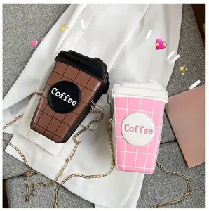Close-up of funny coffee cup shape crossbody bags with chain straps in pink and brown
