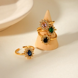 Macro detail of vintage sunflower rings with colorful zircon gems and golden bands