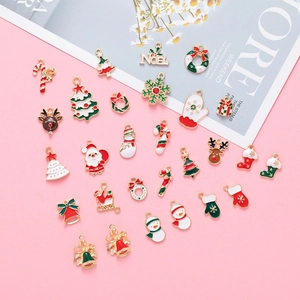 Christmas DIY alloy charms featuring Santa, reindeer and snowman on a pink backdrop