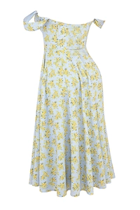 Detail shot of light blue floral dress with thin straps and delicate yellow flower patterns