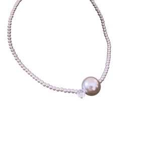 Elegant pearl choker necklace featuring large champagne pearl and faceted crystal accent