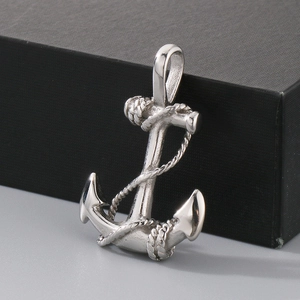 Detailed close-up of a silver anchor pendant with rope texture and polished steel finish