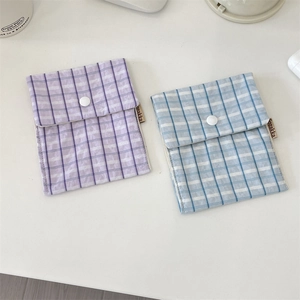 Close-up of light purple and sky blue checkered floral fabric pouch with button