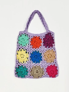 Detailed view of handmade crochet tote bag with colorful floral granny square patches