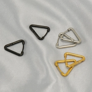 Three pairs of geometric triangular stainless steel hoop earrings in gold silver and black
