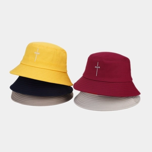 Detail of five colorful cotton bucket hats featuring premium PEACE embroidery in various shades