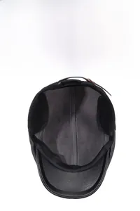 Detail of warm winter baseball cap with faux leather texture and thick fleece lining