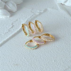 Macro detail of S925 sterling silver enamel hoop earrings with inlaid zircon crystals