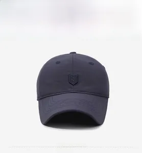 Detailed front view of navy blue winter baseball cap with shield embroidery and reinforced brim