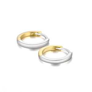 Macro detail of wave curved S925 silver hoop earrings with gold and silver two-tone plating