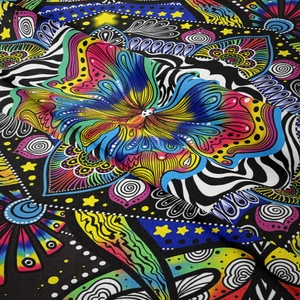 Detailed close-up of bohemian butterfly tapestry fabric with intricate mandala patterns
