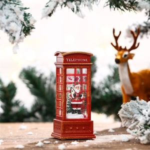 Close-up of red Christmas telephone booth lantern with Santa Claus and festive glitter