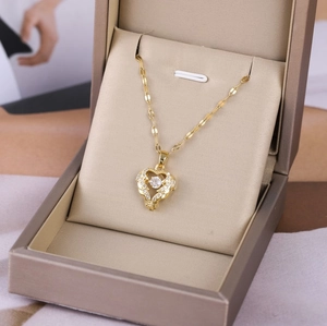 Golden heart pendant necklace with white cubic zirconia in a jewelry gift box