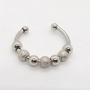 Silver rotatable anxiety ring with smooth and frosted beads on a white background