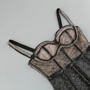Close-up of black mesh dress featuring intricate silver sequins and beadwork details