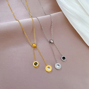 Macro detail of gold and silver Roman numeral necklaces with gems on silk fabric