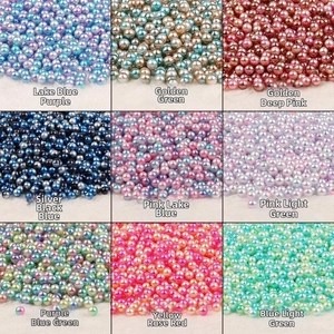 Macro shot of 9 colorful gradient faux pearl beads for DIY jewelry making and decoration