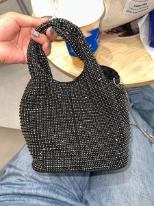 Sparkling black rhinestone bucket bag with silver chain strap for elegant evening wear
