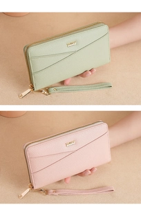 Detail of pink and green pebble leather wallets with gold zipper and wristlet straps