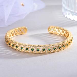 Elegant 18k gold plated hollow mesh bangle featuring green and white zircon stones