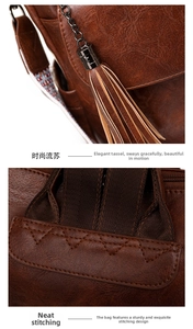 Detail of vintage brown leather backpack with tassel charm and reinforced stitching