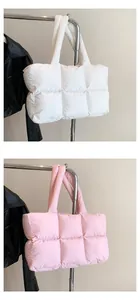 Detail of white and pink quilted puffer tote bags with large square stitching and soft handles