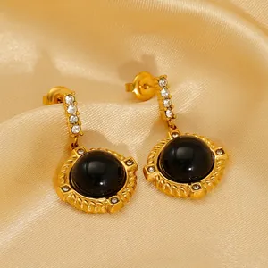 Vintage gold-plated titanium earrings with large round black stone and pavé zircon accents
