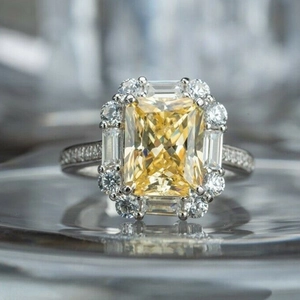 Macro detail of radiant cut yellow zircon ring with halo diamond pavé setting