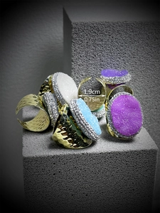 Adjustable bronze ring detail showing 1.9cm width and colorful crystal cluster stone