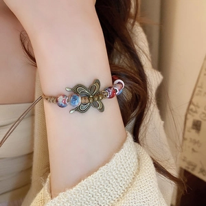 Vintage woven bracelet with bronze butterfly pendant and ceramic beads for women
