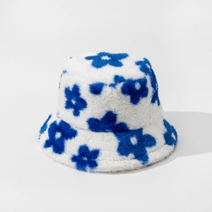 Detailed close-up of thick plush bucket hat with blue floral pattern on white faux fur