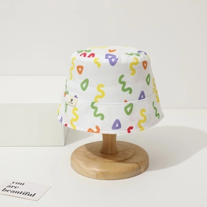 Detail view of baby sun bucket hat with colorful graffiti wave patterns on white canvas