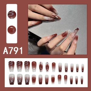 Close-up of long coffin press-on nails with dark brown butterfly and snake patterns