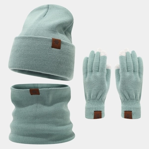 Detail of mint green winter knit set showing faux leather snowflake patch and touchscreen tips