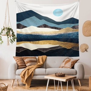Detailed view of large mountain tapestry with abstract blue and gold landscape art