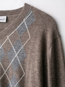 Detailed view of the wool blend diamond argyle knit sweater neckline and size tag