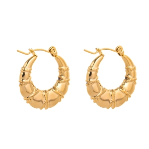 Detailed view of gold hoop earrings with unique bamboo texture and polished finish
