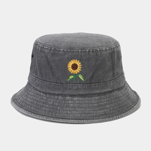 Detailed view of yellow sunflower embroidery on vintage washed denim bucket hat with eyelets