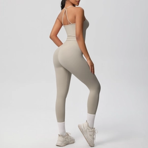 Detail of cross-back straps on beige yoga bodysuit with matte high-elasticity fabric