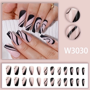 Pink press-on nails set with black swirl patterns and long coffin shape details