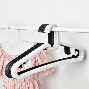 Non-slip plastic clothing hangers in black and white for home and retail storage