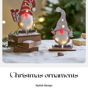 Close-up of wooden Christmas gnomes with glowing LED noses and festive starry lights