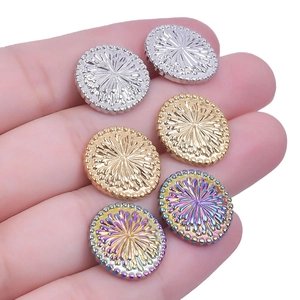 Detailed view of oval geometric stainless steel earrings with radiant sunburst texture