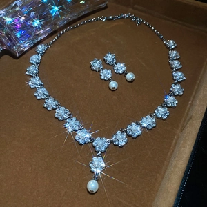 Macro shot of silver flower jewelry set with pearls and diamonds in a luxury velvet box