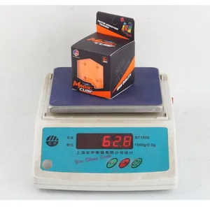 Detailed view of the children's 5.7cm magic cube weighing 62.8g on a digital scale