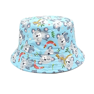 Detail of the light blue bucket hat showing vibrant cartoon koala and floral patterns