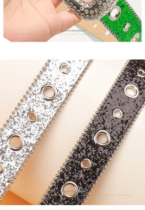 Close-up of punk Y2K belts with rhinestone edges, cracked texture and metal eyelets