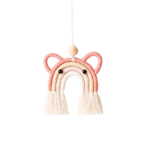 Detail of handmade woven rainbow car ornament with pink cotton fringe and wooden bead