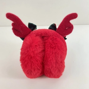 Detail of red plush winter earmuffs with cute reindeer antlers and dark green bows