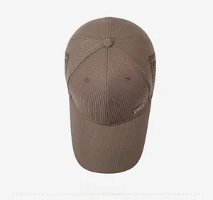 Top-down view of a brown breathable mesh baseball cap with a metal sports tag